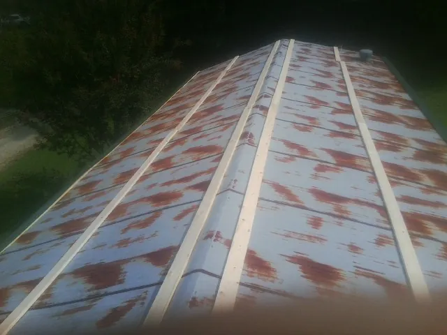 Rusted metal roof panels with new wood purlins before replacement — Storm Damage Roof Repair in Pilot Rock by Roofing Brothers